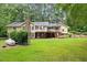 Expansive backyard view with a wooden deck, ideal for outdoor entertaining and enjoying the scenic surroundings at 106 Autumn Cir, Cary, NC 27518