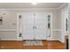Elegant double front doors with sidelights, creating a grand and welcoming entrance at 106 Autumn Cir, Cary, NC 27518