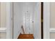 Hallway leading to a stairwell, showing a well-lit passage with white walls and minimal decor at 106 Autumn Cir, Cary, NC 27518