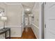 Hallway with hardwood flooring, neutral paint, and access to various rooms at 106 Autumn Cir, Cary, NC 27518