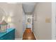 Hallway with hardwood floors leading to a bathroom with vanity at 106 Autumn Cir, Cary, NC 27518