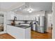 Modern kitchen features stainless steel appliances, white cabinets and granite countertops at 106 Autumn Cir, Cary, NC 27518