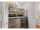 Well-organized laundry area with modern washer and dryer, shelving, and storage at 106 Autumn Cir, Cary, NC 27518