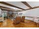 Bright living room with a stone fireplace, exposed beams, and hardwood floors at 106 Autumn Cir, Cary, NC 27518