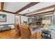 Cozy living room featuring a stone fireplace, exposed beams, and hardwood floors at 106 Autumn Cir, Cary, NC 27518