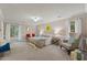Spacious bedroom with windows, an accent chair, and comfortable furnishings creating a relaxing retreat at 106 Autumn Cir, Cary, NC 27518