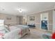 Bright and airy bedroom featuring an ensuite bathroom, bench, and neutral tones at 106 Autumn Cir, Cary, NC 27518