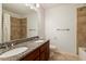 Updated bathroom with double sink vanity, granite countertops, and a tiled shower at 108 Holly Glen Ct, Holly Springs, NC 27540