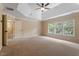 Bright, spacious bedroom with tray ceiling, ceiling fan, and several windows providing lots of natural light at 108 Holly Glen Ct, Holly Springs, NC 27540