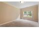 Cozy bedroom featuring a large window and neutral carpeting at 108 Holly Glen Ct, Holly Springs, NC 27540