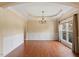 Elegant dining room with hardwood floors, chandelier, and classic wainscoting at 108 Holly Glen Ct, Holly Springs, NC 27540