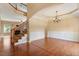Open foyer featuring hardwood floors, staircase, and a formal dining area with elegant chandelier and wainscoting at 108 Holly Glen Ct, Holly Springs, NC 27540
