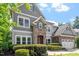 Attractive home with stone accents, gray siding, and a well-maintained front yard with mature landscaping at 108 Holly Glen Ct, Holly Springs, NC 27540