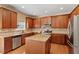 Updated kitchen features wood cabinets, granite countertops and stainless steel appliances at 108 Holly Glen Ct, Holly Springs, NC 27540