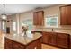 Updated kitchen with wood cabinets, granite countertops, and stainless steel appliances at 108 Holly Glen Ct, Holly Springs, NC 27540