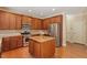 Updated kitchen features wood cabinets, granite countertops and stainless steel appliances at 108 Holly Glen Ct, Holly Springs, NC 27540