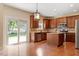 Charming kitchen boasts wood cabinets, granite countertops, stainless steel appliances and hardwood floors at 108 Holly Glen Ct, Holly Springs, NC 27540