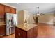 Updated kitchen with wood cabinets, granite countertops, and stainless steel appliances at 108 Holly Glen Ct, Holly Springs, NC 27540