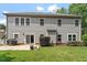 Rear view of home featuring siding, a small patio, and a manicured lawn, perfect for outdoor living and entertaining at 108 Holly Glen Ct, Holly Springs, NC 27540