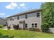 Siding adorns the back of this home, complemented by a small patio and lush backyard space at 108 Holly Glen Ct, Holly Springs, NC 27540