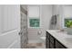 Bright bathroom featuring double sinks, decorative mirror, and window bringing the outdoors in at 109 Box Elder Way, Zebulon, NC 27597