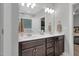 Double sink bathroom vanity with ample storage space, mirrors, and modern fixtures at 109 Box Elder Way, Zebulon, NC 27597