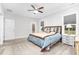A bright, carpeted bedroom features a ceiling fan and natural light at 109 Box Elder Way, Zebulon, NC 27597
