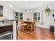 Bright dining area with a large wooden table and lots of natural light from large windows at 109 Box Elder Way, Zebulon, NC 27597
