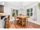 Bright dining area with a large wooden table and lots of natural light from large windows at 109 Box Elder Way, Zebulon, NC 27597