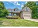 Charming two-story home with a well-manicured lawn and attached two-car garage at 109 Box Elder Way, Zebulon, NC 27597