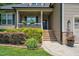 Inviting front porch with decorative flowers and a well-maintained landscape at 109 Box Elder Way, Zebulon, NC 27597