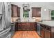 Kitchen boasts stainless steel appliances, dark cabinetry, and granite countertops at 109 Box Elder Way, Zebulon, NC 27597