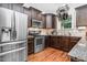 Well-equipped kitchen features stainless steel appliances, dark wood cabinets, and modern countertops at 109 Box Elder Way, Zebulon, NC 27597
