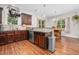 Open kitchen leading to dining area featuring dark wood cabinets and stainless steel appliances at 109 Box Elder Way, Zebulon, NC 27597