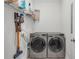 Well-organized laundry room featuring front loading washer and dryer and vacuum cleaner at 109 Box Elder Way, Zebulon, NC 27597