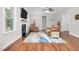 Cozy living room featuring a fireplace, wood floors, and comfortable seating at 109 Box Elder Way, Zebulon, NC 27597