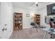 Inviting office with built-in bookshelves, glass desk, and large windows for plenty of natural light at 109 Box Elder Way, Zebulon, NC 27597