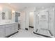 This luxury bathroom features a shower with glass door and double vanity with custom cabinets at 109 Murdock Creek Ct, Cary, NC 27519
