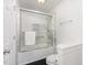 A clean bathroom featuring a shower over tub with white tile and a glass door at 109 Murdock Creek Ct, Cary, NC 27519
