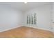 This spacious bedroom features hardwood floors and a window with plantation shutters at 109 Murdock Creek Ct, Cary, NC 27519