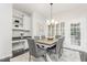 Cozy dining area with modern table and chairs, stylish light fixture, and built-in desk with shelving at 109 Murdock Creek Ct, Cary, NC 27519