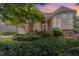Beautiful two-story brick home featuring a lush landscaped front yard with mature trees and a garden bed at 109 Murdock Creek Ct, Cary, NC 27519