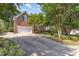 Charming brick home with a two-car garage and a spacious driveway lined with mature trees and landscaping at 109 Murdock Creek Ct, Cary, NC 27519