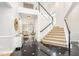 Bright foyer with a grand staircase, black and white tile flooring, and views into the living area at 109 Murdock Creek Ct, Cary, NC 27519