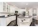 Modern kitchen with white cabinetry, black countertops, stainless steel appliances, and a central island at 109 Murdock Creek Ct, Cary, NC 27519