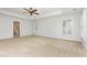 Spacious main bedroom with carpet, ceiling fan and two windows with plantation shutters at 109 Murdock Creek Ct, Cary, NC 27519