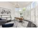 A home office featuring a wooden desk, large windows with shutters, and modern decor at 109 Murdock Creek Ct, Cary, NC 27519