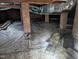 View of the basement with exposed brick and overhead ductwork at 1102 N Guthrie Ave, Durham, NC 27703