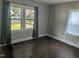 Bedroom with hardwood floors, neutral paint, and natural light from the large windows at 1102 N Guthrie Ave, Durham, NC 27703