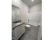 Full bathroom featuring tile flooring, granite counters, and tub with shower at 111 Hot Springs Way, Benson, NC 27504